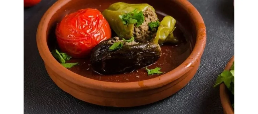 چیدن دلمه بادمجان و فلفل در ظرف پیرکس برای قرار دادن در فر